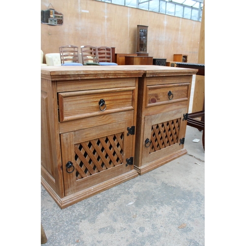 2873 - A PAIR OF MEXICAN PINE BEDSIDE CUPBOARDS WITH LATTICE WORK DOORS