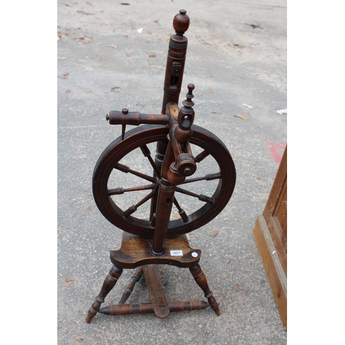 2877 - A BEECH FRAMED SPINNING WHEEL ON TURNED LEGS AND STRETCHERS