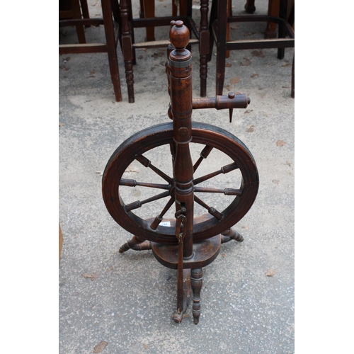 2877 - A BEECH FRAMED SPINNING WHEEL ON TURNED LEGS AND STRETCHERS