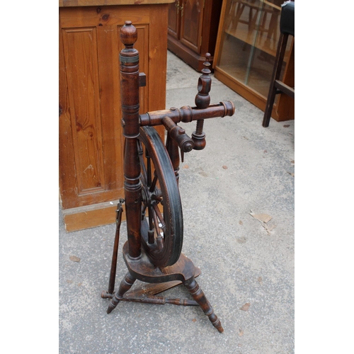 2877 - A BEECH FRAMED SPINNING WHEEL ON TURNED LEGS AND STRETCHERS