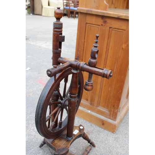 2877 - A BEECH FRAMED SPINNING WHEEL ON TURNED LEGS AND STRETCHERS