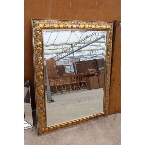 2899 - A MODERN GILT FRAMED WALL MIRROR WITH BEVEL EDGE AND FOLIATE DECORATION, 48