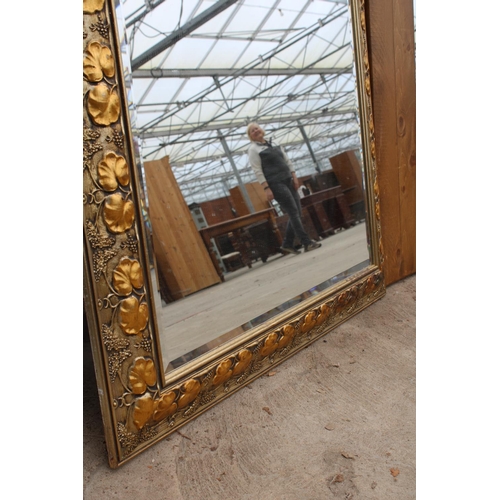 2899 - A MODERN GILT FRAMED WALL MIRROR WITH BEVEL EDGE AND FOLIATE DECORATION, 48