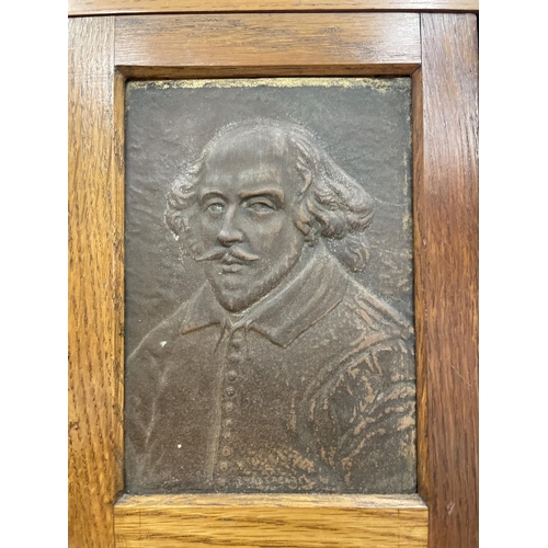 74 - AN EDWARDIAN OAK SMOKERS CABINET DEPICTING WILLIAM SHAKESPEARE WITH THREE SECTIONS. RIGHT HAND DOOR ... 