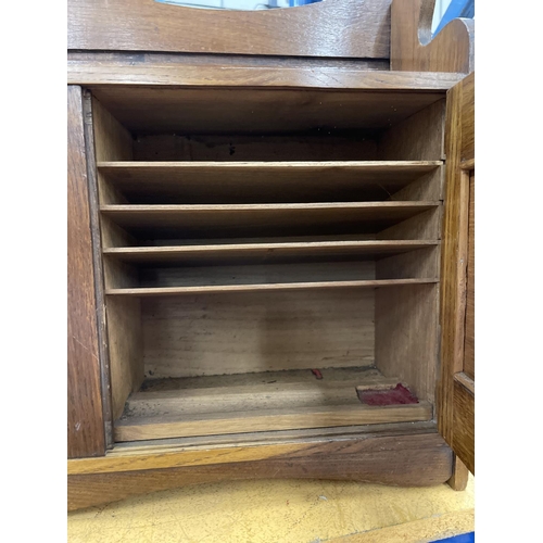 74 - AN EDWARDIAN OAK SMOKERS CABINET DEPICTING WILLIAM SHAKESPEARE WITH THREE SECTIONS. RIGHT HAND DOOR ... 