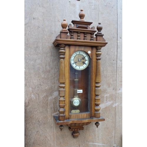 2884A - A VICTORIAN EIGHT DAY WALL CLOCK WITH ROMAN NUMERALS