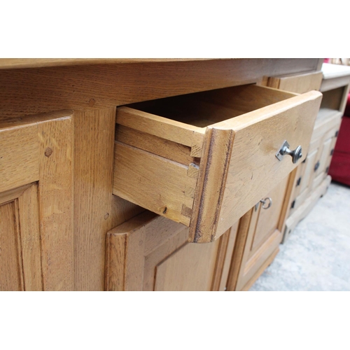 2905 - A MODERN OAK SIDEBOARD ENCLOSING THREE PANELLED DOORS AND SINGLE DRAWER, 68