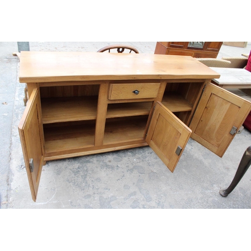 2905 - A MODERN OAK SIDEBOARD ENCLOSING THREE PANELLED DOORS AND SINGLE DRAWER, 68