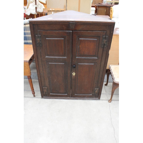 2932 - A GEORGE III OAK TWO DOOR PANELLED CORNER CUPBOARD, 36.5