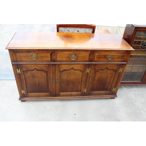 2949 - AN OAK GEORGE III STYLE DRESSER BASE, ENCLOSING 3 DRAWERS AND 3 PANELLED CUPBOARDS, WITH 'H' BRASS H... 