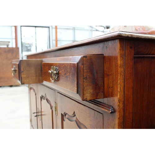 2949 - AN OAK GEORGE III STYLE DRESSER BASE, ENCLOSING 3 DRAWERS AND 3 PANELLED CUPBOARDS, WITH 'H' BRASS H... 