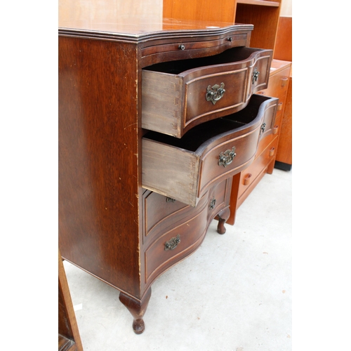 2975 - A REPRODUCTION MAHOGANY SERPENTINE CHEST OF DRAWERS WITH PULL OUT WRITING SLIDE AND FOUR LONG DRAWER... 