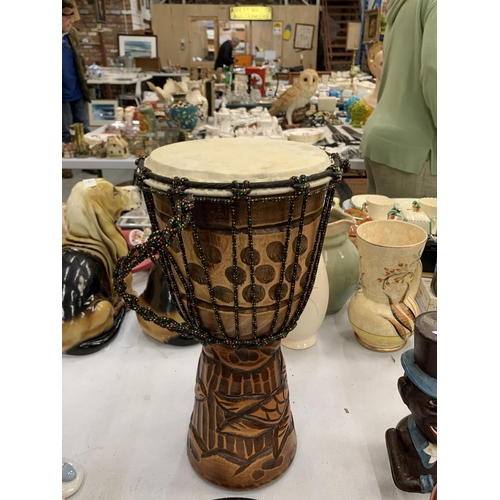 116A - A WOODEN HAND CARVED BONGO DRUM