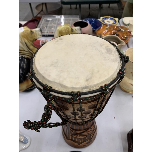 116A - A WOODEN HAND CARVED BONGO DRUM