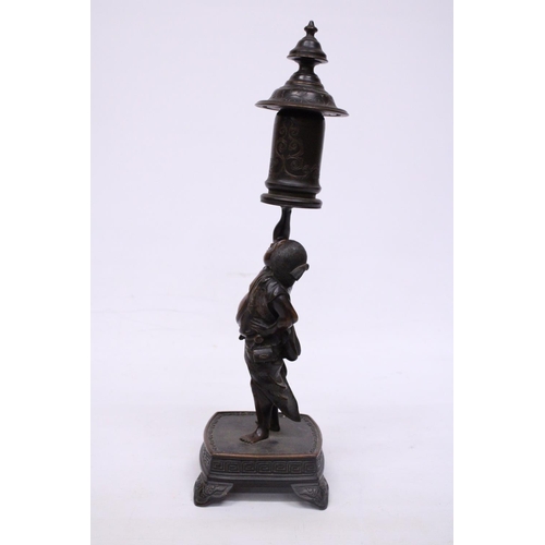 301 - A BRONZE MEIJI PERIOD STATUE OF A FIGURE HOLDING A VASE WITH COVER