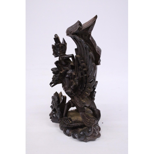 322 - A WOOD CARVING OF GARUDA WITH THE GOD VISHNU - 29 CM (H)