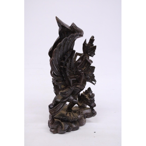 322 - A WOOD CARVING OF GARUDA WITH THE GOD VISHNU - 29 CM (H)