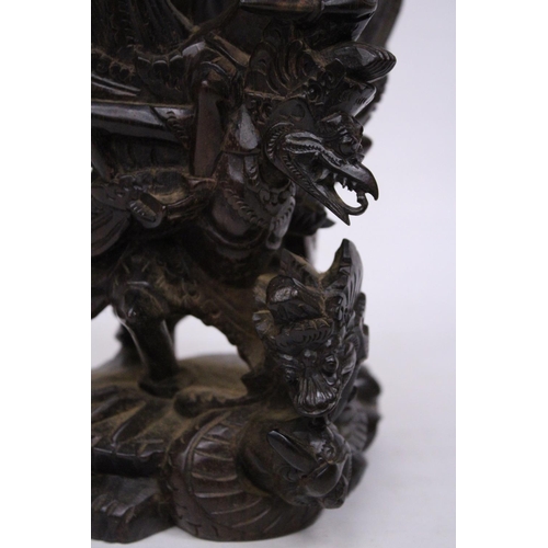 322 - A WOOD CARVING OF GARUDA WITH THE GOD VISHNU - 29 CM (H)