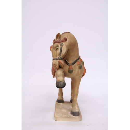 323 - A CHINESE HORSE IN THE STYLE OF A TANG DYNASTY WARRIOR HORSE - 30 CM INCLUDE BASE