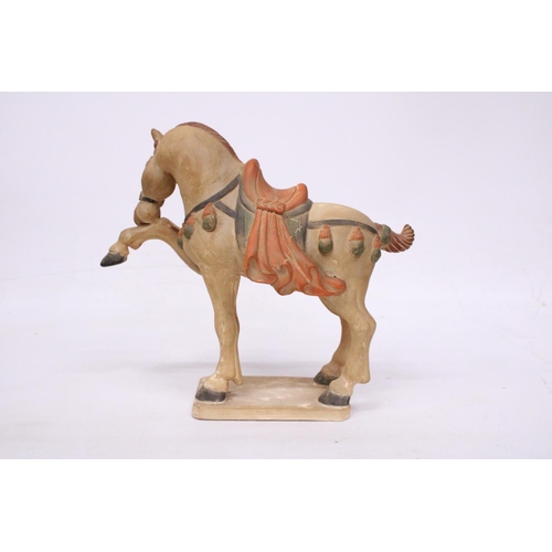 323 - A CHINESE HORSE IN THE STYLE OF A TANG DYNASTY WARRIOR HORSE - 30 CM INCLUDE BASE