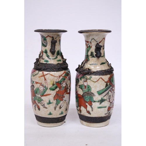 335 - A PAIR OF CHINESE CRACKLE GLAZED VASES WITH WARRIOR SCENES - 18 CM (H) - MARK TO BASE