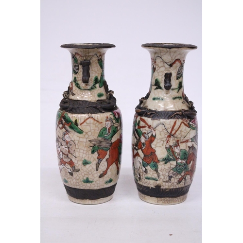 335 - A PAIR OF CHINESE CRACKLE GLAZED VASES WITH WARRIOR SCENES - 18 CM (H) - MARK TO BASE