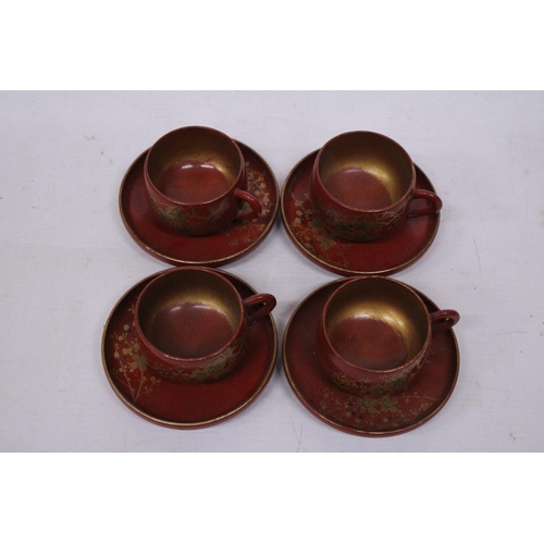 360 - A VINTAGE SET OF CHINESE GILT AND RED LACQUERED DESIGN TEA CUPS AND SAUCERS