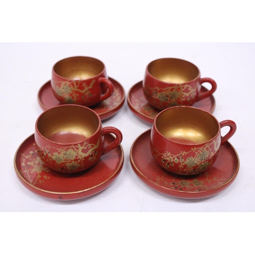 360 - A VINTAGE SET OF CHINESE GILT AND RED LACQUERED DESIGN TEA CUPS AND SAUCERS