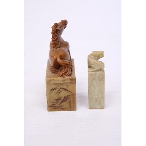 381 - A CHINESE CARVED SOAPSTONE SEAL DEPICTING A REARING HORSE TOGETHER WITH A LION SEAL CARVING