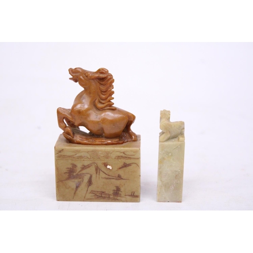 381 - A CHINESE CARVED SOAPSTONE SEAL DEPICTING A REARING HORSE TOGETHER WITH A LION SEAL CARVING