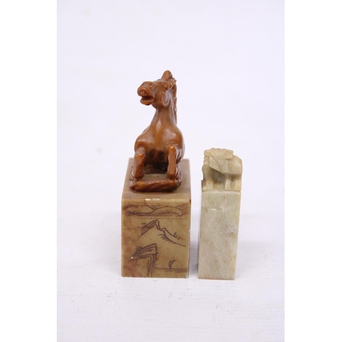 381 - A CHINESE CARVED SOAPSTONE SEAL DEPICTING A REARING HORSE TOGETHER WITH A LION SEAL CARVING