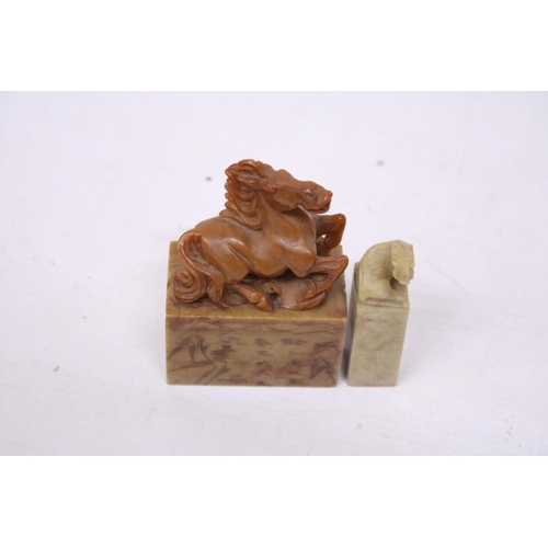 381 - A CHINESE CARVED SOAPSTONE SEAL DEPICTING A REARING HORSE TOGETHER WITH A LION SEAL CARVING