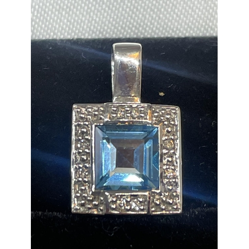 505 - A 9 CARAT WHITE GOLD SQUARE PENDANT WITH CENTRE BLUE TOPAZ SURROUNDED BY DIAMONDS IN A PRESENTATION ... 