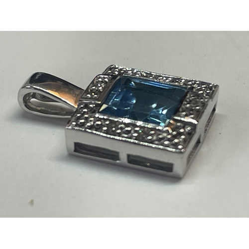 505 - A 9 CARAT WHITE GOLD SQUARE PENDANT WITH CENTRE BLUE TOPAZ SURROUNDED BY DIAMONDS IN A PRESENTATION ... 