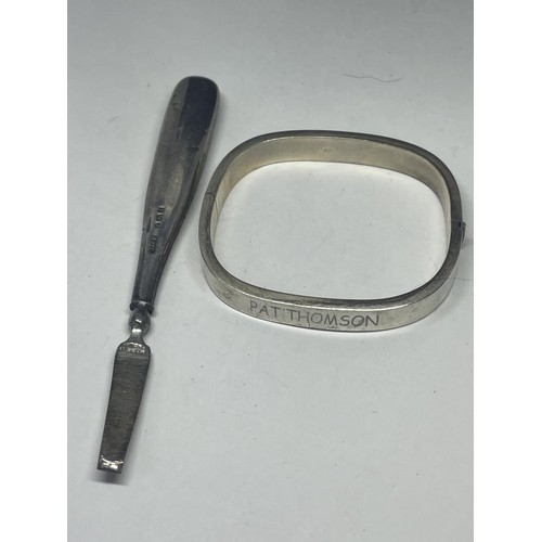 549 - A SILVER BANGLE AND A SILVER HANDLED NAIL FILE