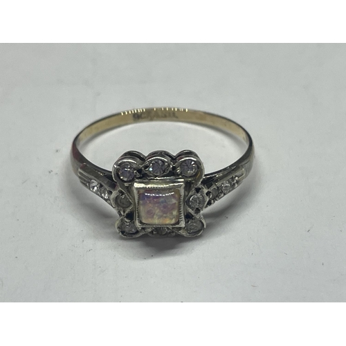 556 - A 9 CARAT GOLD ON SILVER SETTING ASSORTED STONE RING