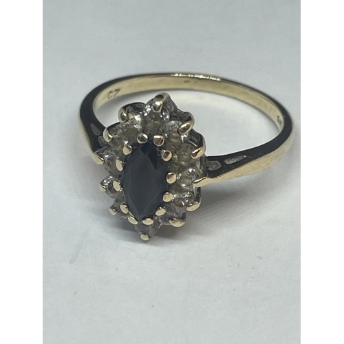 656 - A 9 CARAT GOLD RING WITH CENTRE SAPPHIRE SURROUNDED BY CUBIC ZIRCONIAS SIZE N/O