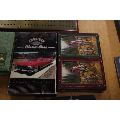 931 - A BRASS CRIB BOARD AND THREE PACKS OF VINTAGE CARDS