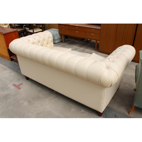 2863 - A MODERN CREAM FAUX LEATHER CHESTERFIELD THREE SEATER SETTEE