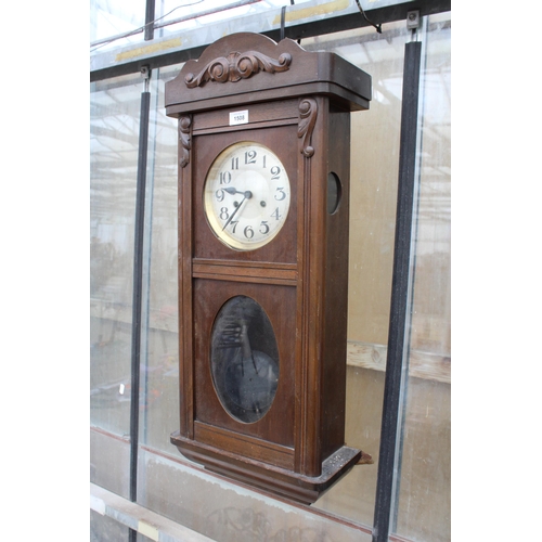 1508 - AN OAK CHIMING WALL CLOCK