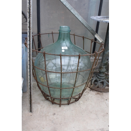 1510 - A LARGE VINTAGE GLASS CARBOY WITH WIRE CRATE