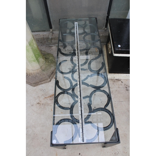 1517 - A VINTAGE STYLE METAL COFFEE TABLE WITH GLASS TOP AND FORMED FROM HORSE SHOES