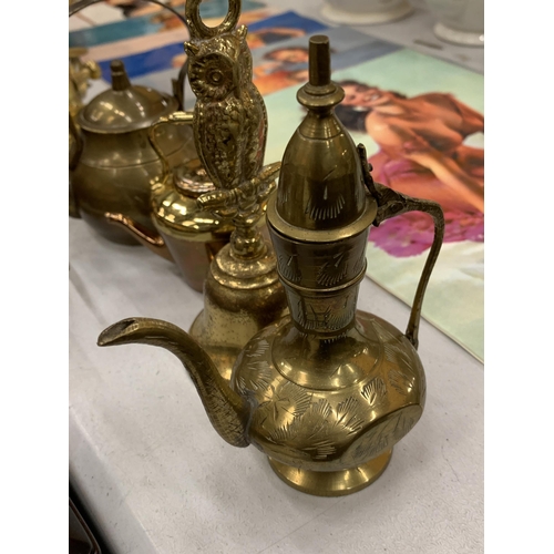 131 - A COLLECTION OF BRASS ITEMS TO INCLUDE KETTLES, BELLS, CANDLESTICKS, ETC.,