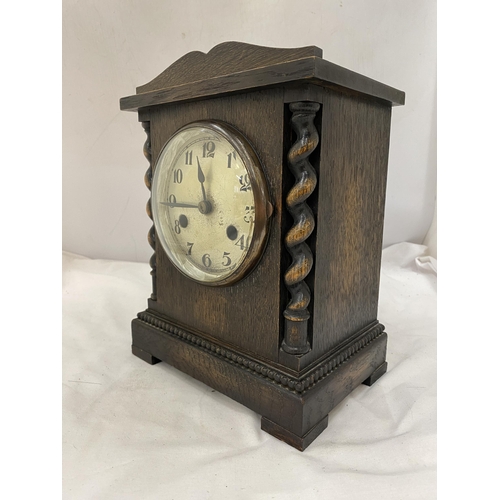 136 - A WOODEN MANTLE CLOCK WITH BARLEY TWIST DESIGN