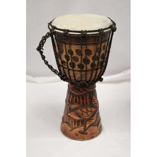 200 - A WOODEN HAND CARVED BONGO DRUM APPROXIMATELY 40CM HIGH