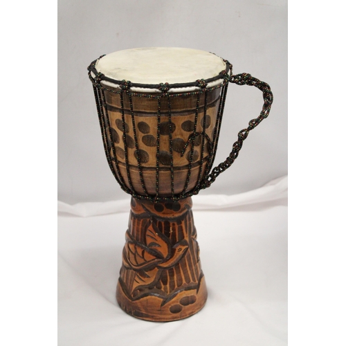 200 - A WOODEN HAND CARVED BONGO DRUM APPROXIMATELY 40CM HIGH