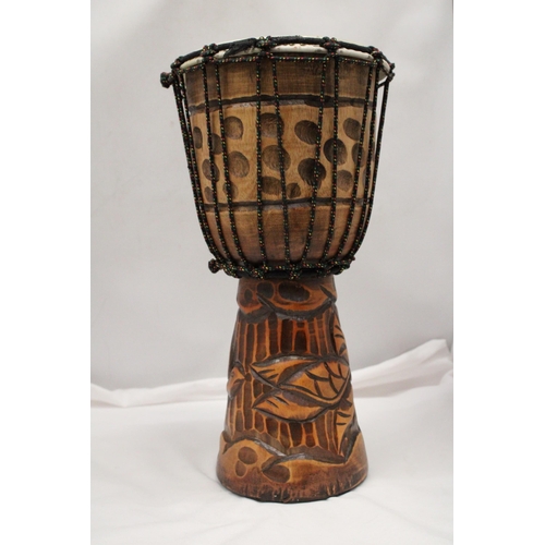 200 - A WOODEN HAND CARVED BONGO DRUM APPROXIMATELY 40CM HIGH