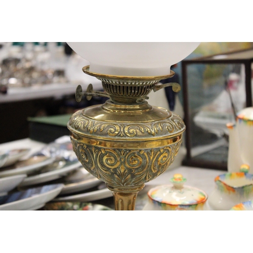 206 - A VINTAGE BRASS OIL LAMP WITH ENGRAVING, A FUNNEL AND ROUND ETCHED GLASS SHADE, HEIGHT APPROX 53CM