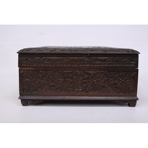 394 - AN ANGLO INDIAN HEAVILY CARVED BOX WITH KEY