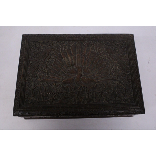 394 - AN ANGLO INDIAN HEAVILY CARVED BOX WITH KEY